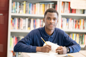 Student sitting at desk writing an assignment